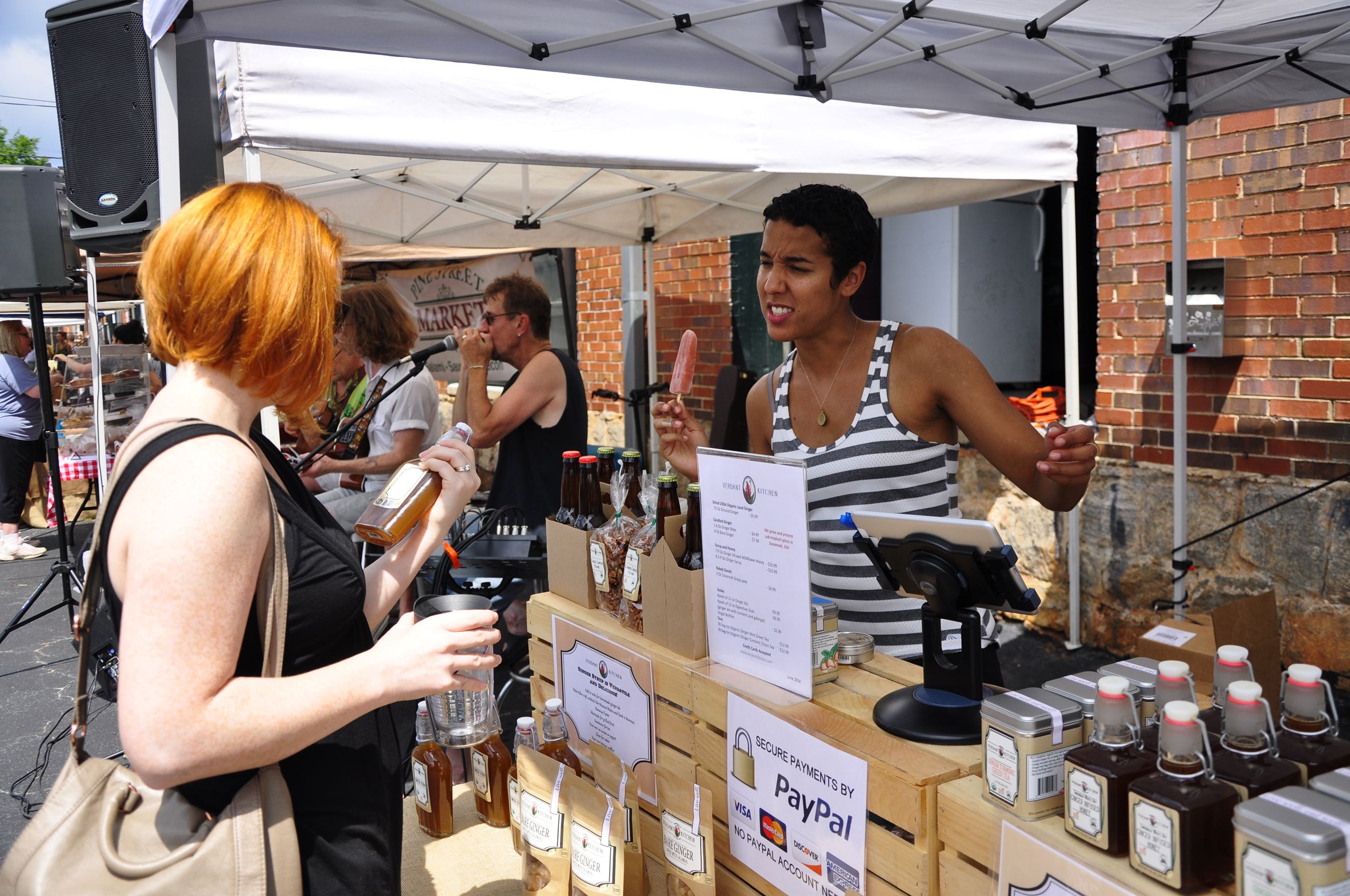 Women Talking at an Outdoor Booth