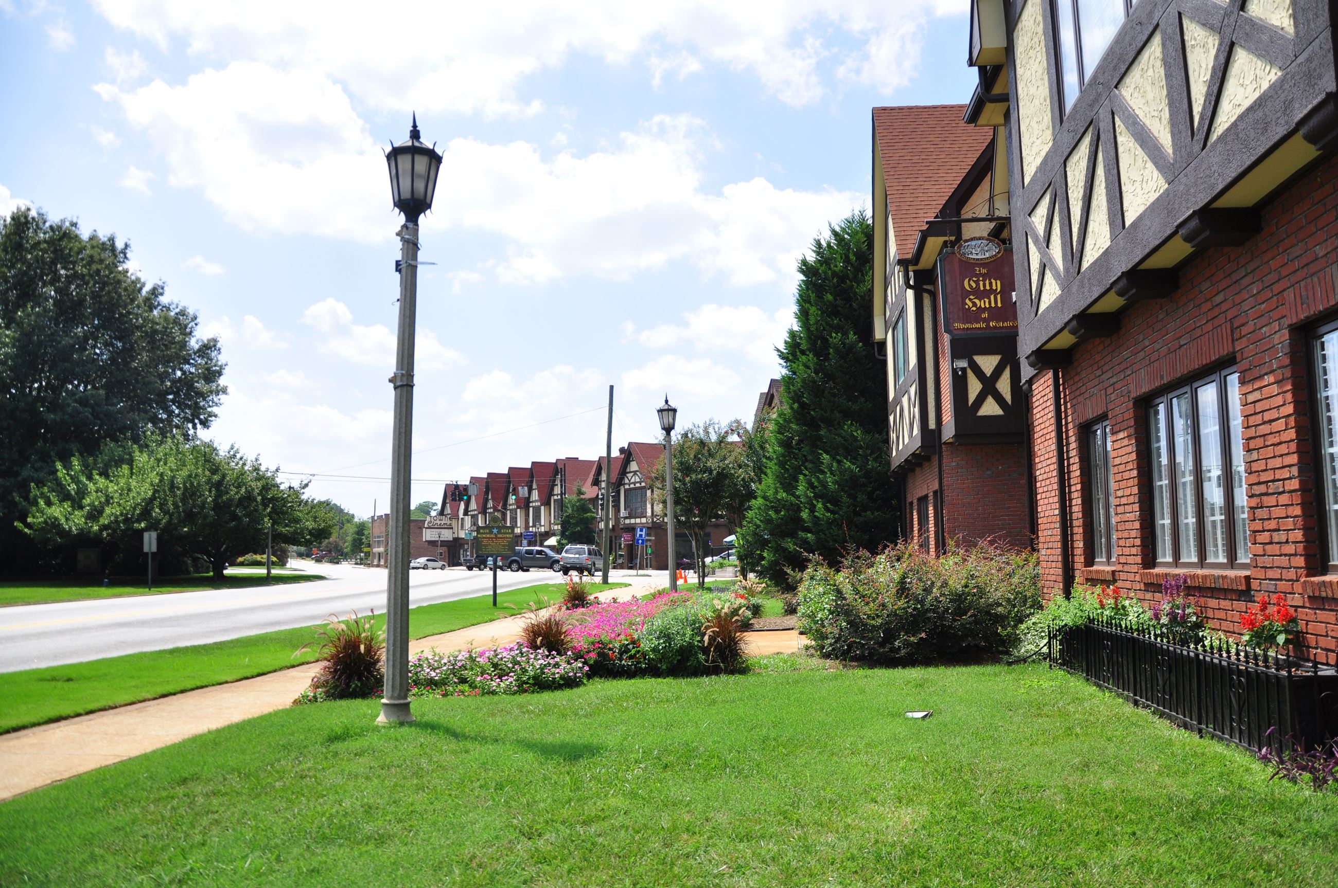 Beautiful green lawns in front of tudor style buildings.
