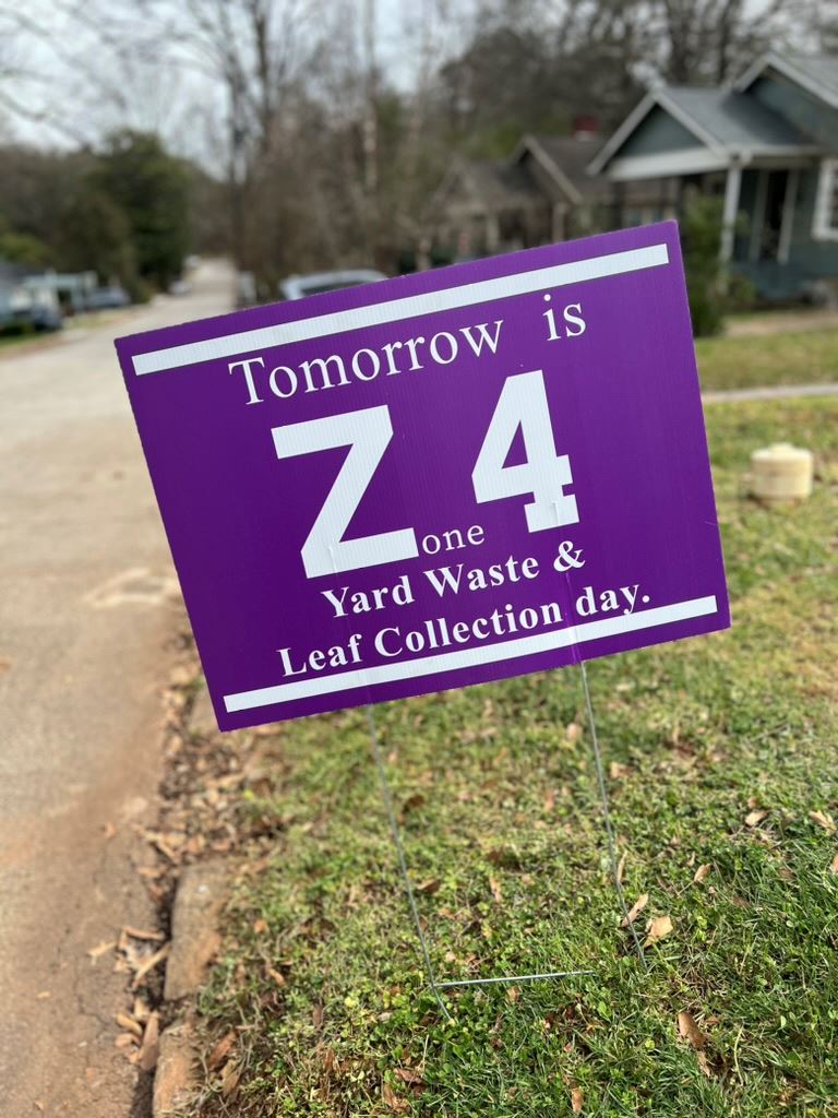 purple yard waste zone sign in front yard